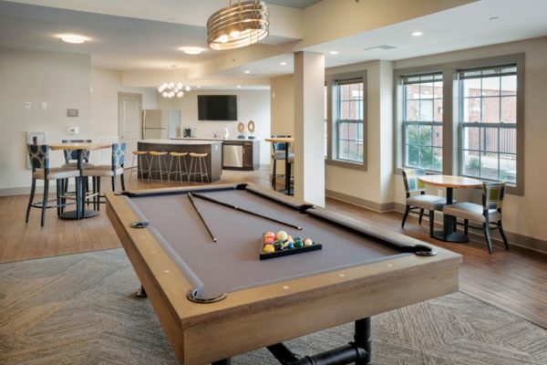beautiful lounge area at Summit Court with pool table and tables and chairs